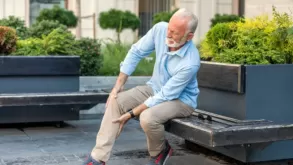 Senior Man Holding His Knee Due To Pain