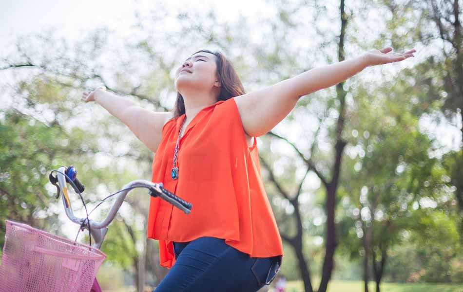 woman enjoying a bike ride on a sunny day