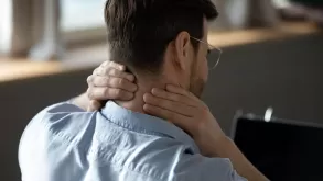 Closeup Of Man Suffering From Neck Pain